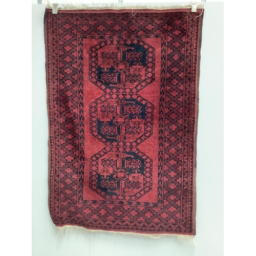 24 - Two Afghan red ground rugs, larger 170 x 120cm