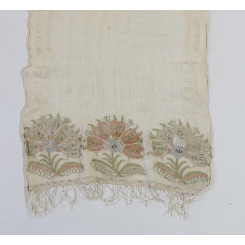 266 - A 19th century Turkish towel, embroidered with flower motifs, in pastel shades, with fine silk fring... 