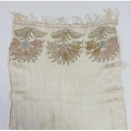 266 - A 19th century Turkish towel, embroidered with flower motifs, in pastel shades, with fine silk fring... 