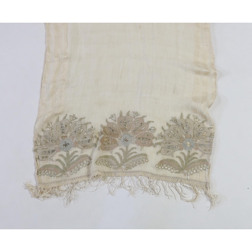 266 - A 19th century Turkish towel, embroidered with flower motifs, in pastel shades, with fine silk fring... 