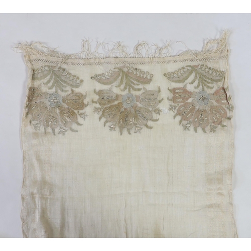 266 - A 19th century Turkish towel, embroidered with flower motifs, in pastel shades, with fine silk fring... 