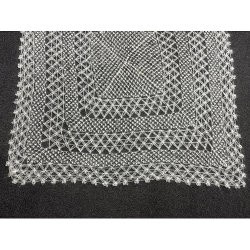 268 - A 20th century central Turkish hand spun and knitted mohair shawl, knitted in an open geometric lace... 