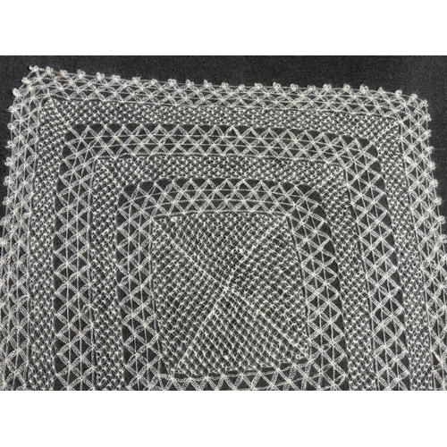 268 - A 20th century central Turkish hand spun and knitted mohair shawl, knitted in an open geometric lace... 