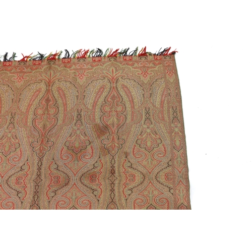 276 - An 1860s, reversible woven wool Paisley shawl, woven with green, red, ochre and brown, with a woven... 