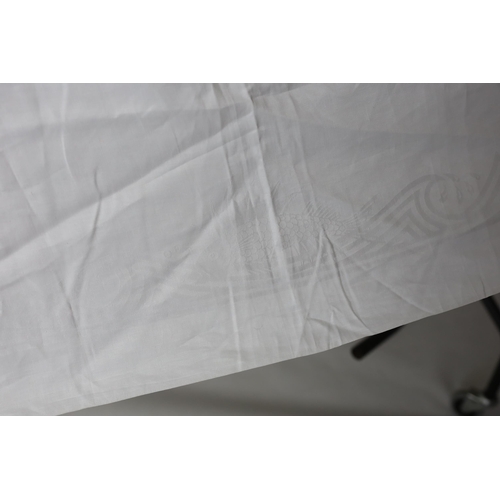 281 - An early 20th century white linen damask table cloth, the design partly inspired by William de Morga... 