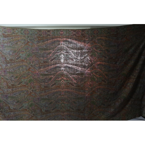 308 - An 1860s-70s Scottish Paisley wool shawl, woven with multi coloured wools in a large scrolling tea... 