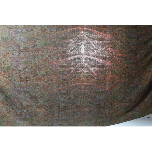 308 - An 1860s-70s Scottish Paisley wool shawl, woven with multi coloured wools in a large scrolling tea... 