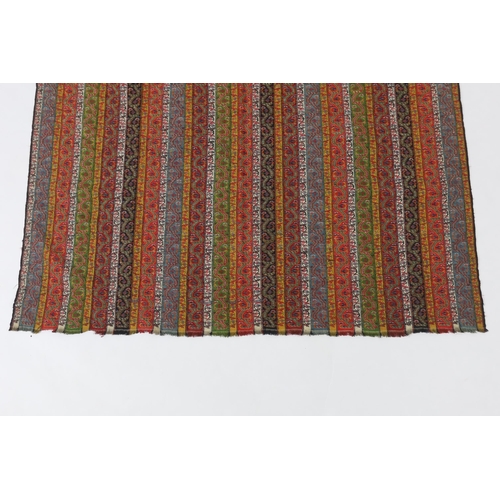 318 - A 19th century Kashmir, multi coloured, striped twill, woven wool shawl, with the fringe cut one end... 