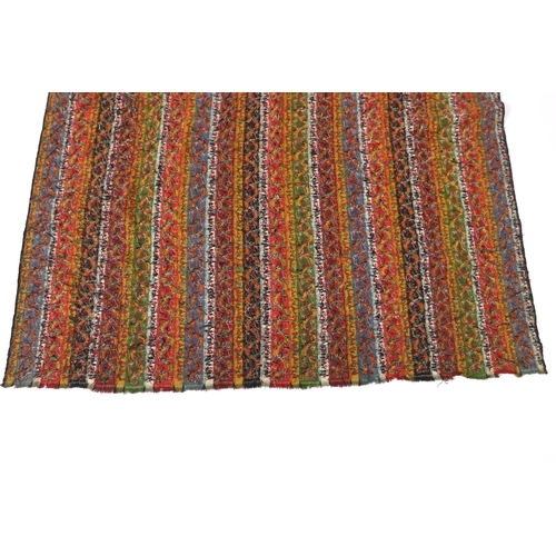 318 - A 19th century Kashmir, multi coloured, striped twill, woven wool shawl, with the fringe cut one end... 