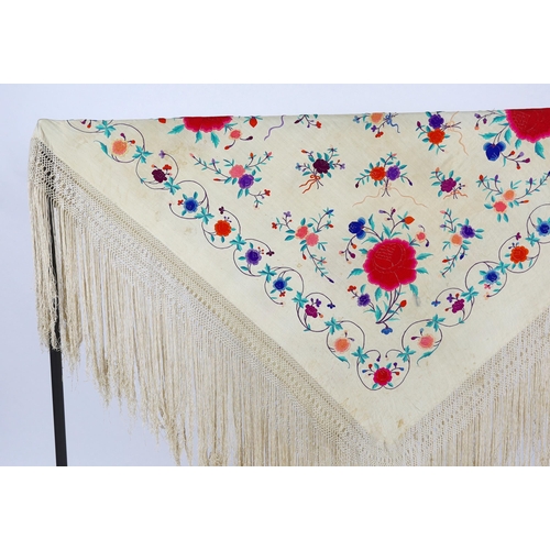 322 - A late 19th / early 20th century cream silk fringed shawl, embroidered with all over polychrome silk... 