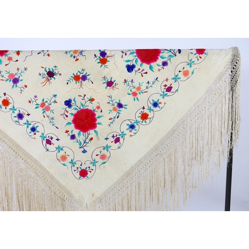 322 - A late 19th / early 20th century cream silk fringed shawl, embroidered with all over polychrome silk... 