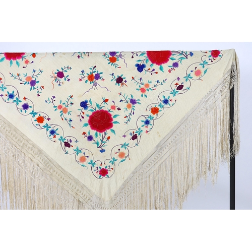 322 - A late 19th / early 20th century cream silk fringed shawl, embroidered with all over polychrome silk... 