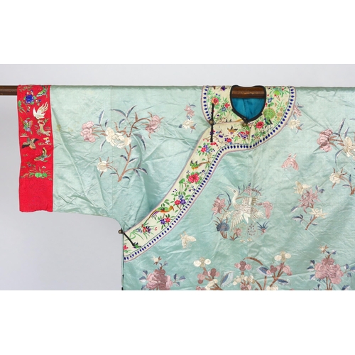 332 - An early 20th century Chinese silk embroidered turquoise robe, embroidered in pastel silk with butte... 