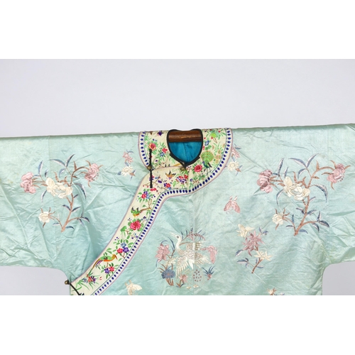 332 - An early 20th century Chinese silk embroidered turquoise robe, embroidered in pastel silk with butte... 