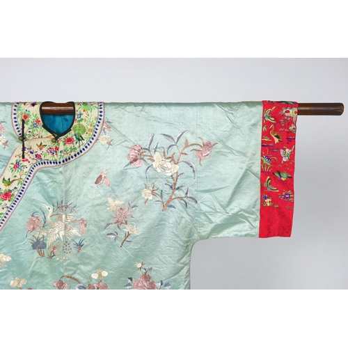 332 - An early 20th century Chinese silk embroidered turquoise robe, embroidered in pastel silk with butte... 