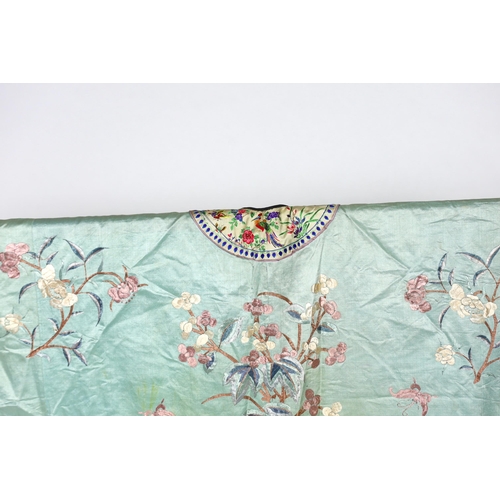 332 - An early 20th century Chinese silk embroidered turquoise robe, embroidered in pastel silk with butte... 