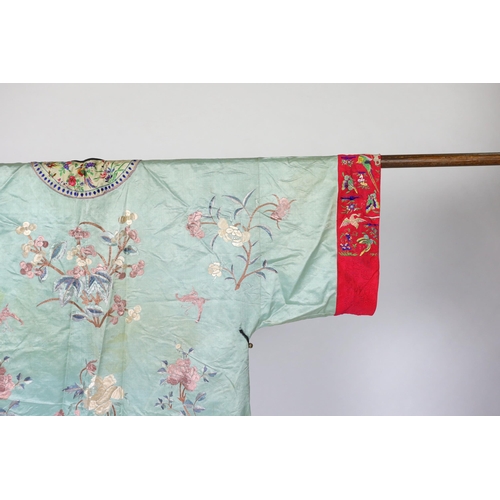 332 - An early 20th century Chinese silk embroidered turquoise robe, embroidered in pastel silk with butte... 