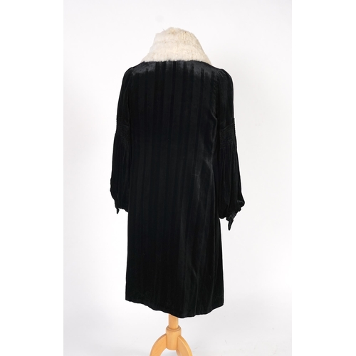 338 - A 1920's ladies black striped silk velvet opera coat with a wide white fur collar and cream satin li... 