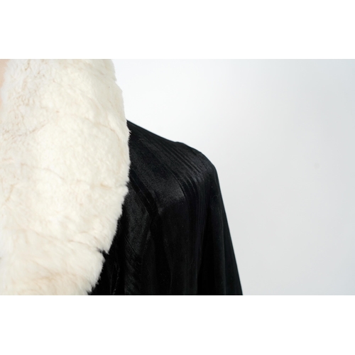 338 - A 1920's ladies black striped silk velvet opera coat with a wide white fur collar and cream satin li... 