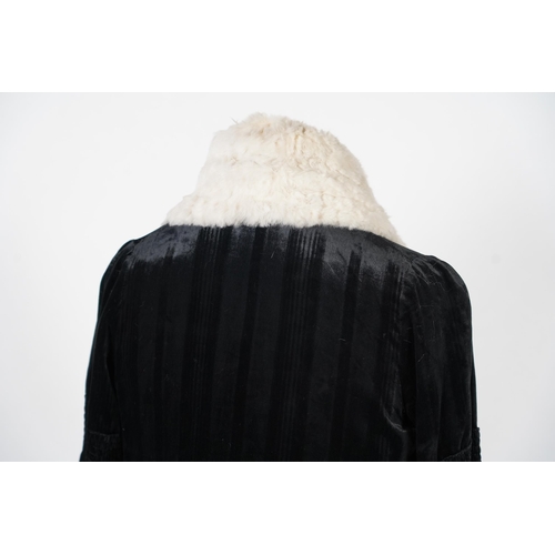 338 - A 1920's ladies black striped silk velvet opera coat with a wide white fur collar and cream satin li... 