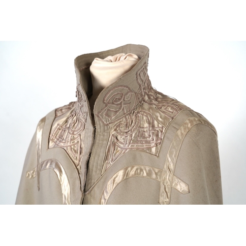 339 - An Edwardian mushroom wool evening cape, decorated with silk ribbon worked strapping and ornate appl... 