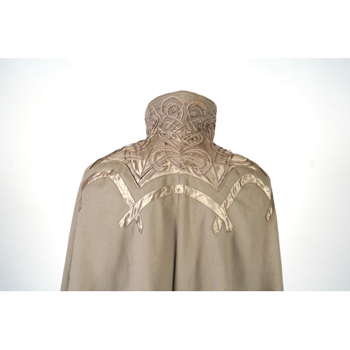 339 - An Edwardian mushroom wool evening cape, decorated with silk ribbon worked strapping and ornate appl... 