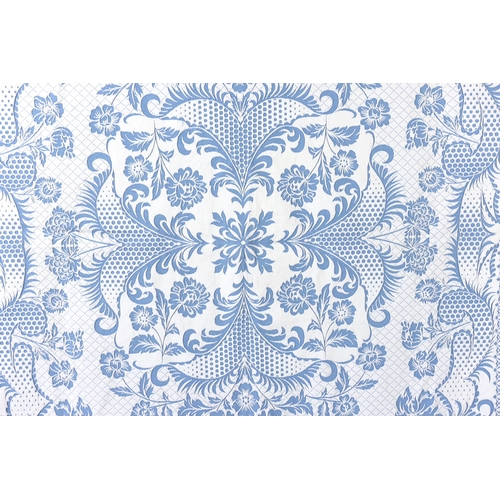 344 - An early 20th century woven 'Marcella' style bed cover, with a blue ground and a white raised floral... 