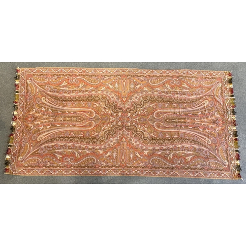 353 - A 19th century woven Scottish Paisley wool shawl, bordered on four sides and fringed on two, woven w... 