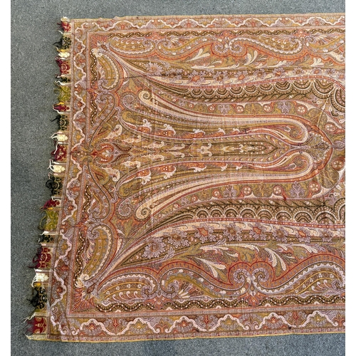 353 - A 19th century woven Scottish Paisley wool shawl, bordered on four sides and fringed on two, woven w... 