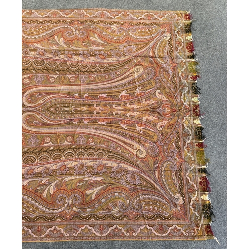 353 - A 19th century woven Scottish Paisley wool shawl, bordered on four sides and fringed on two, woven w... 