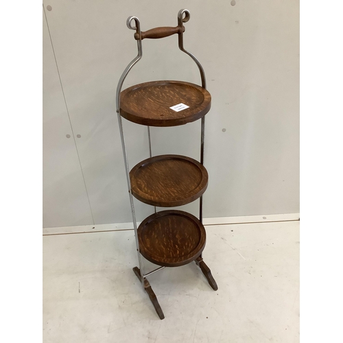 36 - An oak and steel folding cake stand, height 92cm