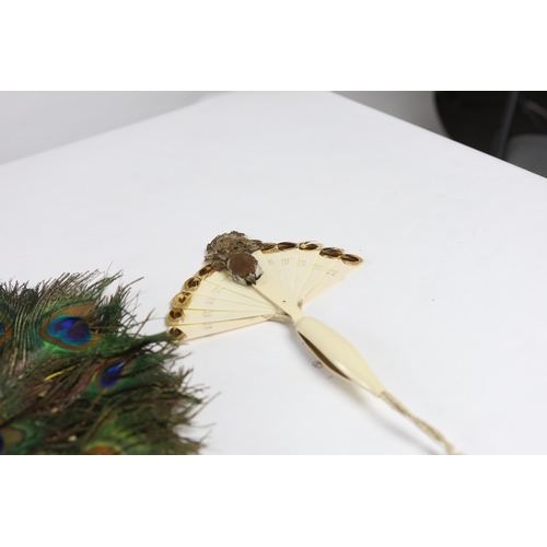 360 - Two Edwardian early 1920s feather fans with unusual bird decoration together with a peacock fan, on... 