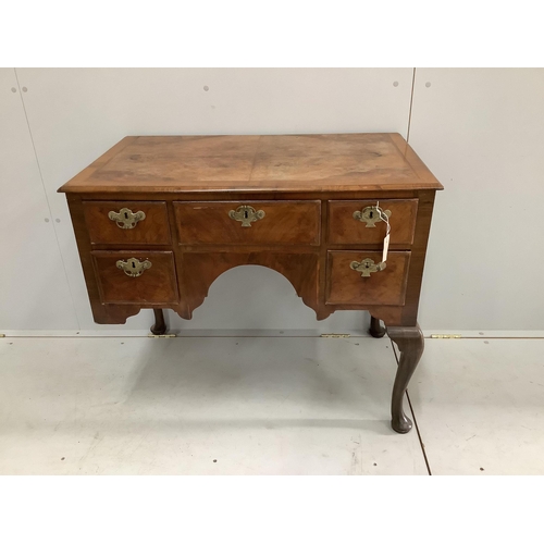 37 - A Queen Anne Revival feather banded walnut kneehole dressing table (front leg a/f), width 88cm, dept... 