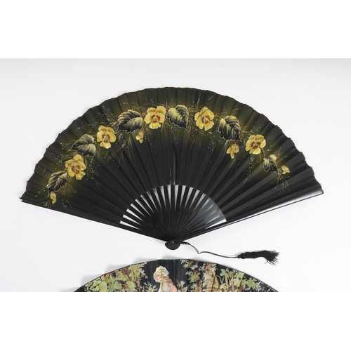 373 - Two early 20th century ebony fans, one cotton leaf, the other hand painted pansies on a fine a silk ... 