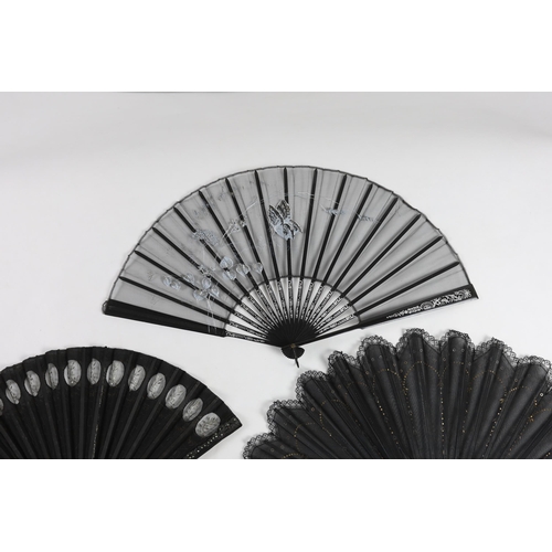 375 - An Edwardian black silk and ornate sequin fan, a similar fan with carved ebony guards and a fine gau... 