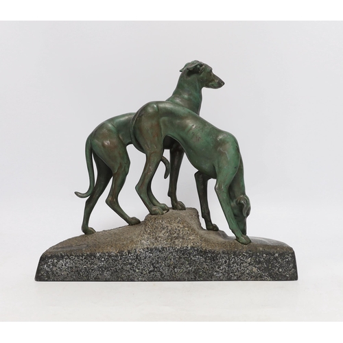 402 - An early 20th century patinated spelter model of two hounds on a granite base, 29cm