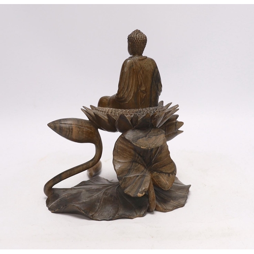 412 - A Thai carved hardwood model of a Buddha on a lotus, damaged, loose piece, 22cm