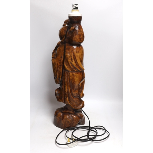 473 - A Chinese carved wood figural lamp, 65cm high