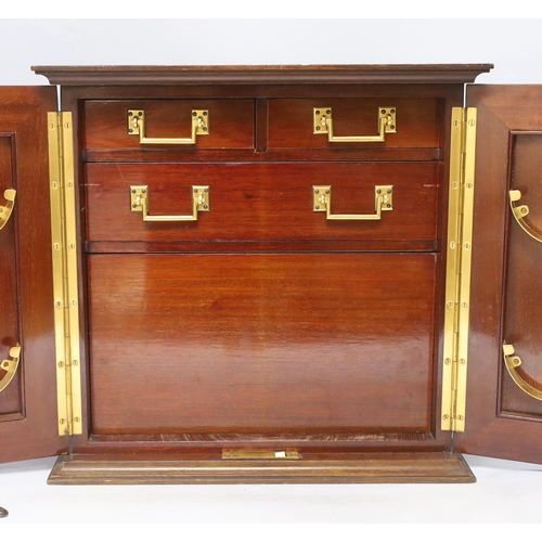 486 - A mahogany smoker's cabinet with tobacco jar and three Jose L Piedra Cuba cigars, 35cm high