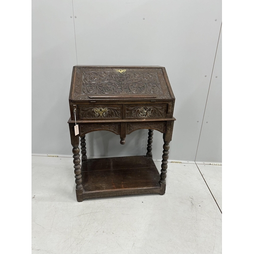 51 - A carved oak bureau, width 68cm, depth 48cm, height 97cm