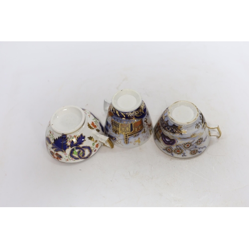 512 - Eleven 1800-1820 English porcelain coffee cans and tea cups, including Imari pattern examples, one w... 