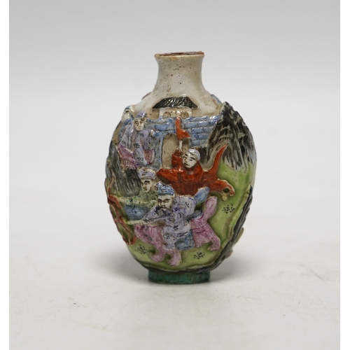 537 - A Chinese moulded in enamelled porcelain figures riding mythical beasts snuff bottle, Qianlong mar... 