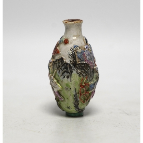 537 - A Chinese moulded in enamelled porcelain figures riding mythical beasts snuff bottle, Qianlong mar... 