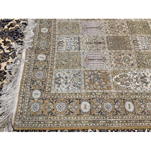 55 - A Kashmir silk rug, woven all over with rectangles filled with stylised flowers, 220 x 138cm... 