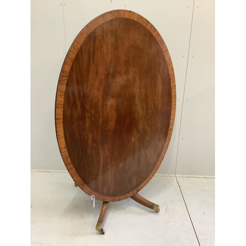 56 - A George III and later satinwood banded oval mahogany tilt top dining table, width 152cm, depth 103c... 