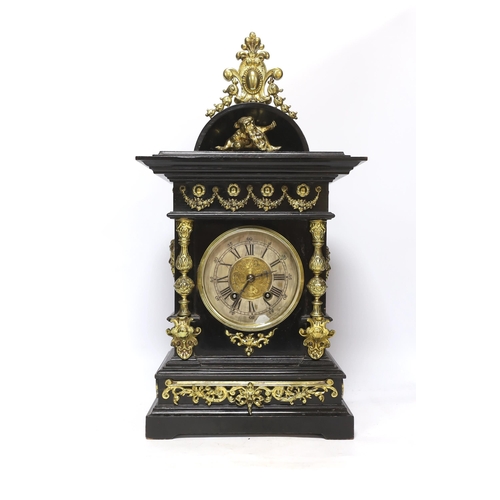 565 - An ebonised German bracket clock with brass decoration, with a Lenzkirch movement striking on a coil... 