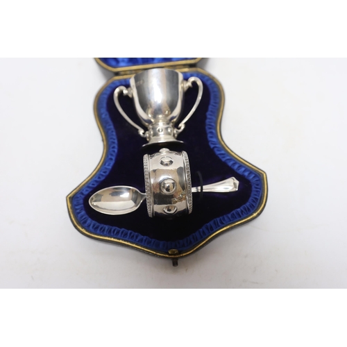 852 - A cased Edwardian matched silver christening pair, (egg cup and napkin ring), Wakeley & Wheeler, Lon... 