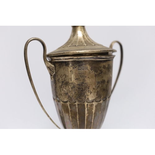 853 - A George V silver two handled trophy cup and cover, London, 1910, on an ebonised base, cup height on... 