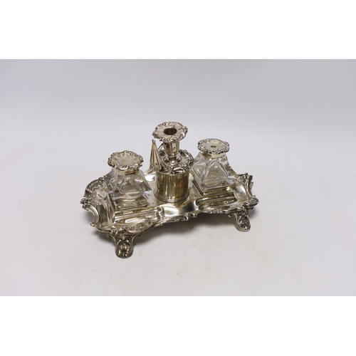 854 - An early Victorian ornate silver inkstand, with two mounted glass wells and central taperstick, Henr... 