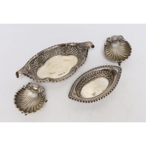 868 - A pair of Victorian silver shell salts, on dolphin supports, London, 1876, 69mm and a two pierced si... 